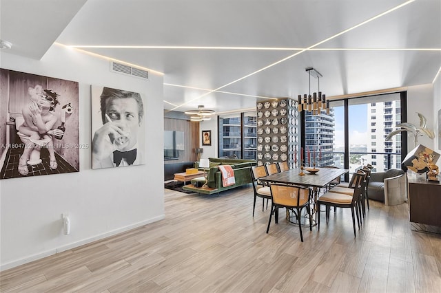 801 S Miami Ave Unit 3510, Miami, FL 33130 - dining room featuring wood finished floors, a chandelier, expansive windows, and baseboards