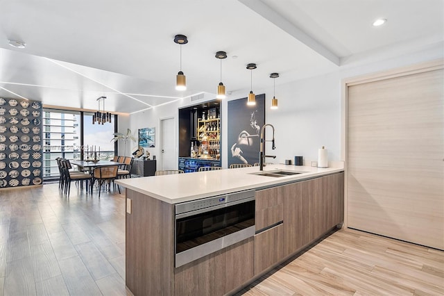 801 S Miami Ave Unit 3510, Miami, FL 33130 - kitchen with a sink, modern cabinets, light wood-type flooring, light countertops, and floor to ceiling windows