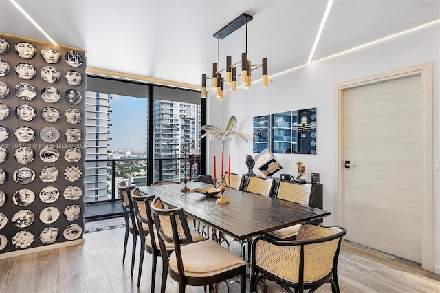 801 S Miami Ave Unit 3510, Miami, FL 33130 - dining room with a chandelier and light wood-style flooring