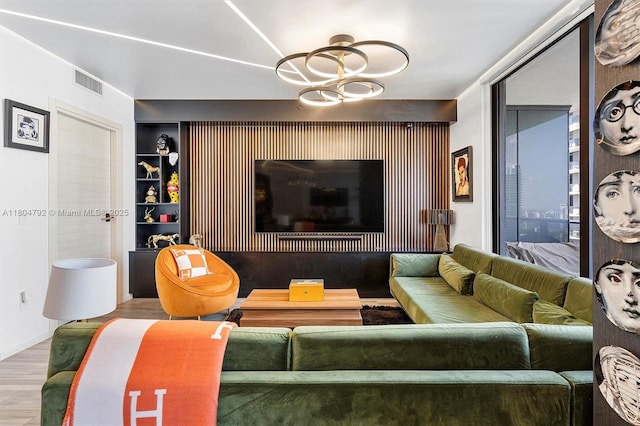 801 S Miami Ave Unit 3510, Miami, FL 33130 - living room with wood finished floors, built in shelves, and a chandelier