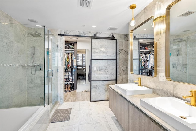 801 S Miami Ave Unit 3510, Miami, FL 33130 - full bath featuring tile walls, a stall shower, a spacious closet, double vanity, and recessed lighting