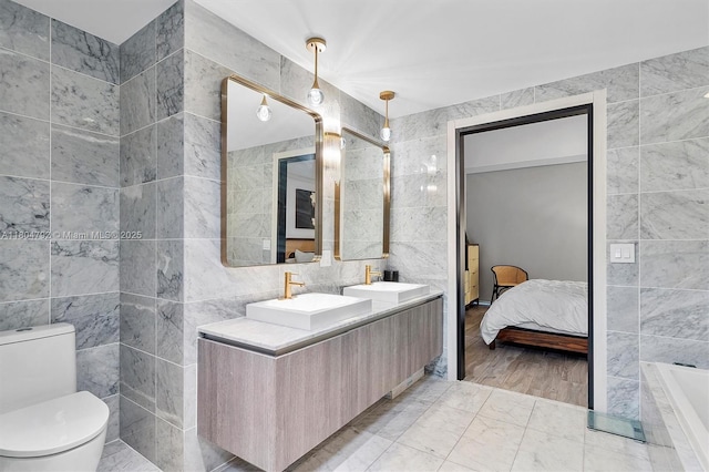 801 S Miami Ave Unit 3510, Miami, FL 33130 - full bath with tile walls, toilet, double vanity, connected bathroom, and a tub