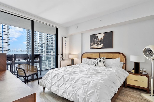 801 S Miami Ave Unit 3510, Miami, FL 33130 - bedroom featuring expansive windows and wood finished floors