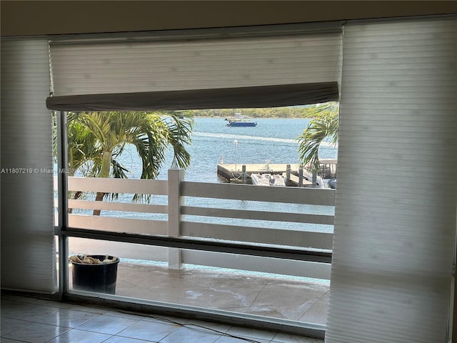 2700 NE 135th St Unit 56, North Miami, FL 33181 - doorway to outside with a water view and tile patterned flooring