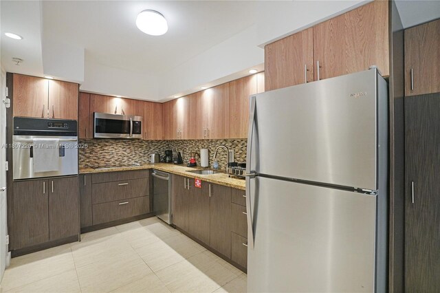 4001 S Ocean Dr Unit 3P, Hollywood, FL 33019 - kitchen featuring appliances with stainless steel finishes, a sink, backsplash, and light tile patterned floors