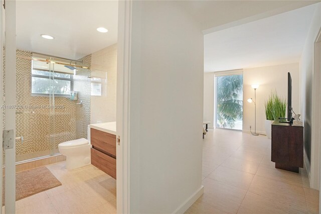 4001 S Ocean Dr Unit 3P, Hollywood, FL 33019 - full bathroom featuring vanity, toilet, a stall shower, and tile patterned floors