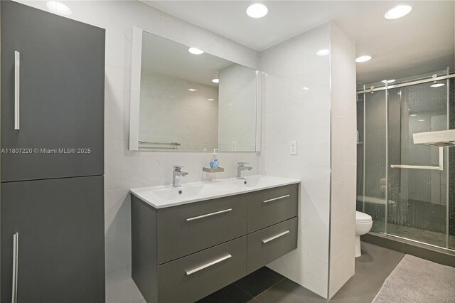 4001 S Ocean Dr Unit 3P, Hollywood, FL 33019 - full bathroom featuring toilet, a stall shower, double vanity, tile patterned flooring, and recessed lighting