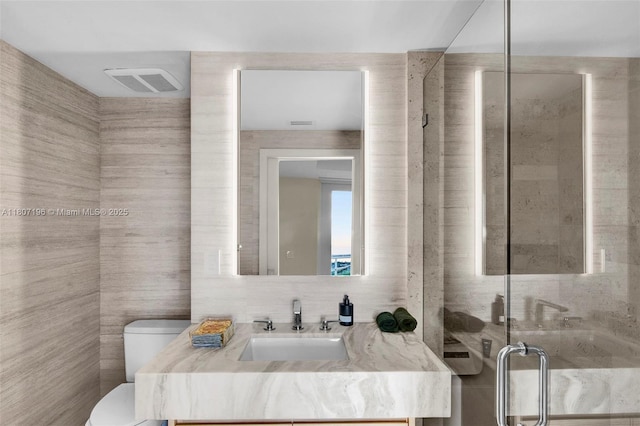 5600 Collins Ave Ph C, Ph C, Miami Beach, FL 33140 - full bath with tile walls, toilet, vanity, and a stall shower