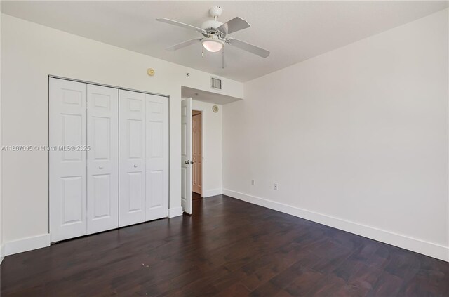 2000 N Bayshore Dr Unit 228, Miami, FL 33137 - unfurnished bedroom with dark wood-style floors, baseboards, a closet, and a ceiling fan