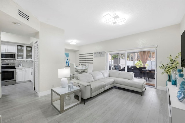 8252 NW 191st Ln Unit 15R, Hialeah, FL 33015 - living area with light wood-style flooring and baseboards