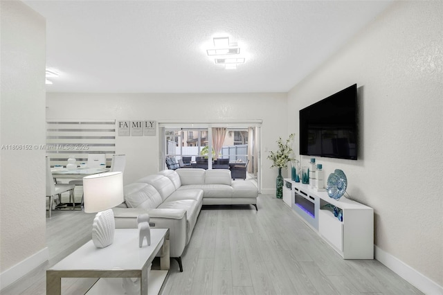 8252 NW 191st Ln Unit 15R, Hialeah, FL 33015 - living room with wood finished floors, baseboards, and a textured wall