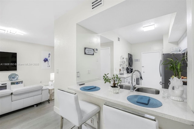 8252 NW 191st Ln Unit 15R, Hialeah, FL 33015 - kitchen with a sink, dishwashing machine, freestanding refrigerator, light wood finished floors, and light stone counters