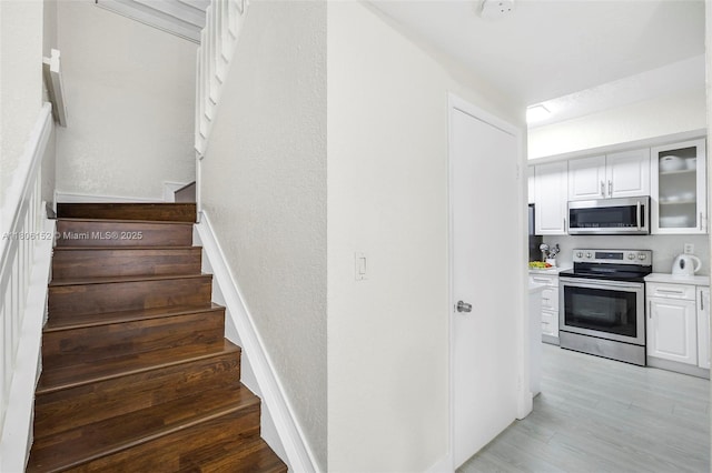 8252 NW 191st Ln Unit 15R, Hialeah, FL 33015 - stairway featuring wood finished floors and a textured wall