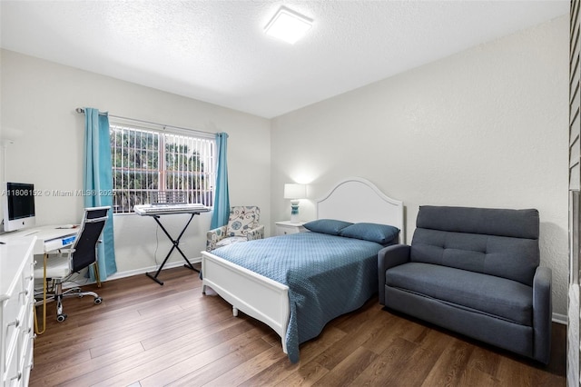 8252 NW 191st Ln Unit 15R, Hialeah, FL 33015 - bedroom with a desk, wood finished floors, and a textured ceiling