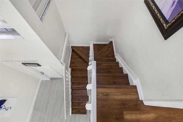 8252 NW 191st Ln Unit 15R, Hialeah, FL 33015 - stairway featuring wood finished floors, baseboards, and a textured wall