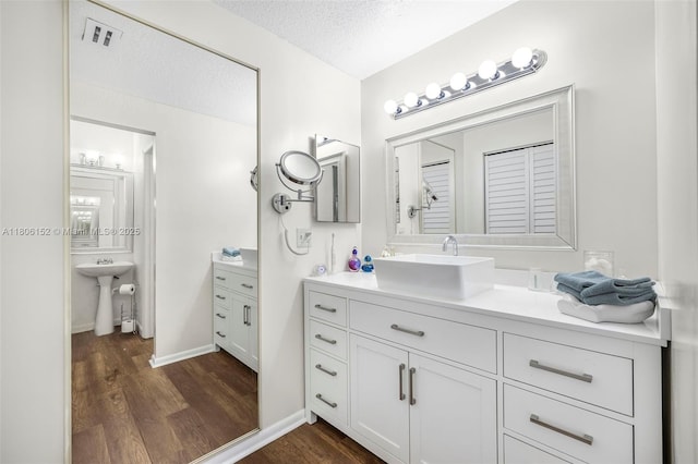 8252 NW 191st Ln Unit 15R, Hialeah, FL 33015 - bathroom with a sink, wood finished floors, and a textured ceiling