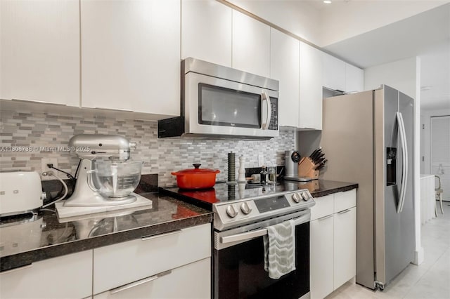 800 Claughton Island Dr Unit 1504, Miami, FL 33131 - kitchen featuring stainless steel appliances, tasteful backsplash, white cabinets, and light tile patterned flooring