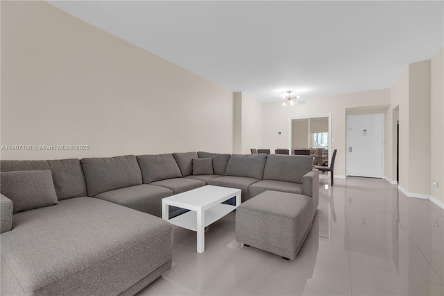 4400 Hillcrest Dr Unit 107A, Hollywood, FL 33021 - living room featuring light tile patterned floors, baseboards, and a chandelier