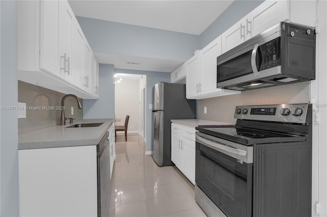 4400 Hillcrest Dr Unit 107A, Hollywood, FL 33021 - kitchen with appliances with stainless steel finishes, a sink, white cabinetry, and light countertops