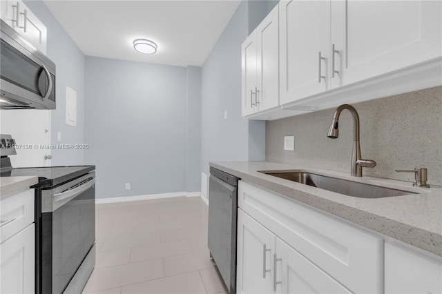4400 Hillcrest Dr Unit 107A, Hollywood, FL 33021 - kitchen featuring stainless steel appliances, a sink, tasteful backsplash, white cabinets, and light stone countertops