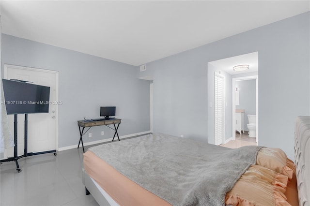 4400 Hillcrest Dr Unit 107A, Hollywood, FL 33021 - bedroom featuring baseboards, tile patterned floors, and connected bathroom