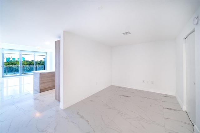 16385 Biscayne Blvd Unit 417, North Miami Beach, FL 33160 - unfurnished room with light marble finish floors and baseboards