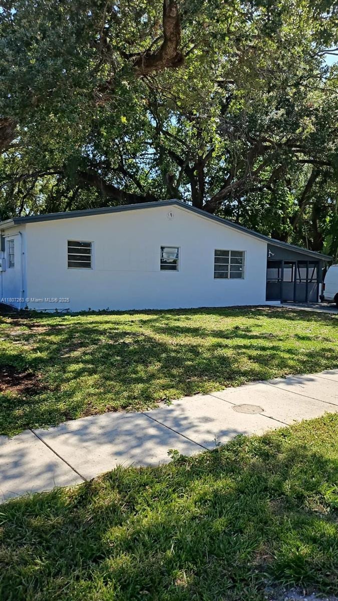 4110 SW 32nd Ct, West Park, FL 33023 - view of side of property with a yard and stucco siding