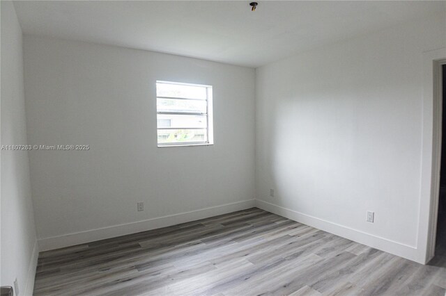 4110 SW 32nd Ct, West Park, FL 33023 - empty room with wood finished floors and a pendent fire sprinkler