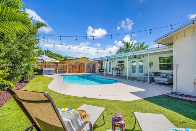 6847 NW 24th Way, Fort Lauderdale, FL 33309 - view of swimming pool featuring french doors, ceiling fan, a fenced backyard, outdoor lounge area, and a patio