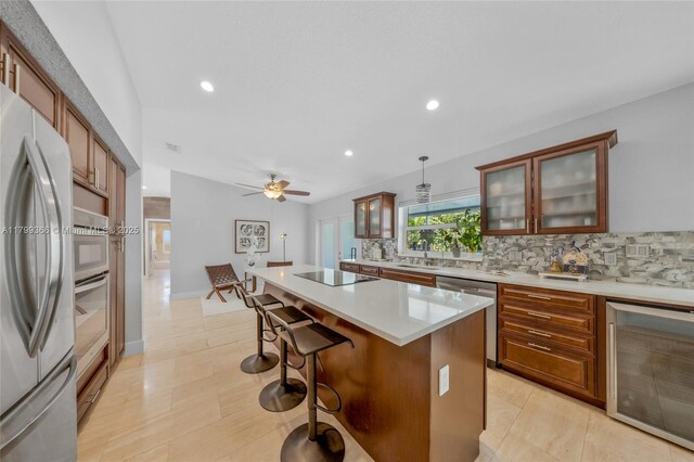 6847 NW 24th Way, Fort Lauderdale, FL 33309 - kitchen featuring beverage cooler, appliances with stainless steel finishes, backsplash, recessed lighting, and light countertops