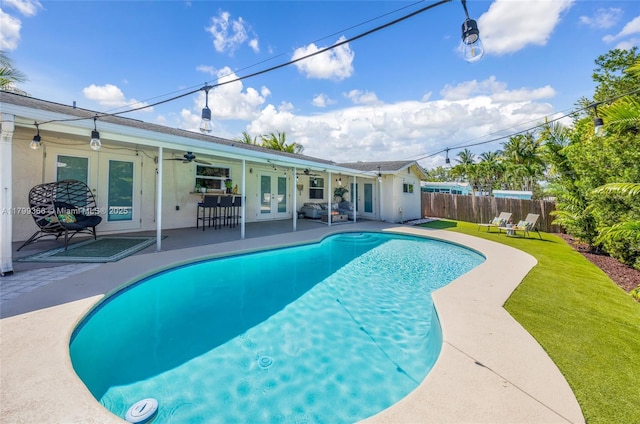 6847 NW 24th Way, Fort Lauderdale, FL 33309 - view of swimming pool with french doors, ceiling fan, and a patio area