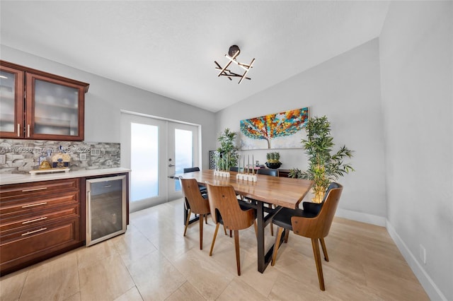 6847 NW 24th Way, Fort Lauderdale, FL 33309 - dining space with wine cooler, french doors, vaulted ceiling, bar area, and a chandelier
