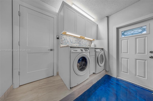 6847 NW 24th Way, Fort Lauderdale, FL 33309 - laundry room featuring washing machine and clothes dryer, a textured ceiling, and cabinet space
