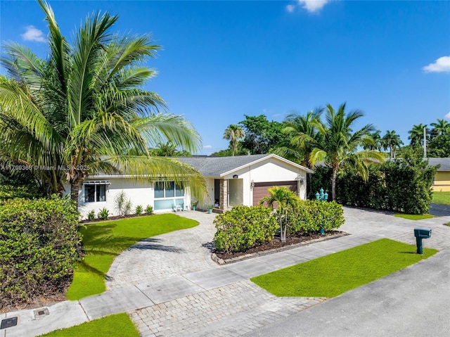 6847 NW 24th Way, Fort Lauderdale, FL 33309 - single story home featuring decorative driveway, an attached garage, a front lawn, and stucco siding