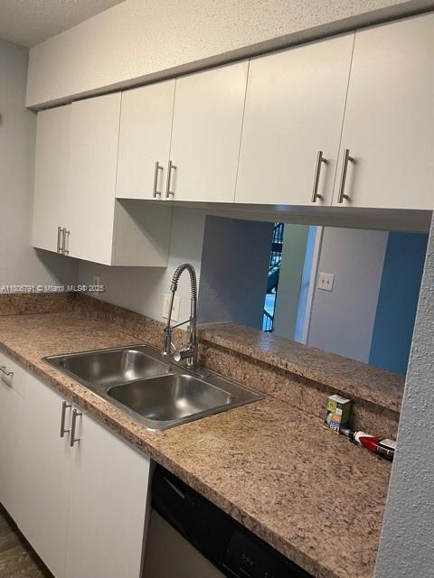 927 Riverside Dr Unit 326, Coral Springs, FL 33071 - kitchen with a sink, white cabinets, and stainless steel dishwasher