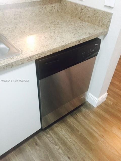 927 Riverside Dr Unit 326, Coral Springs, FL 33071 - kitchen view of dishwasher, light wood-style flooring, light countertops, and baseboards