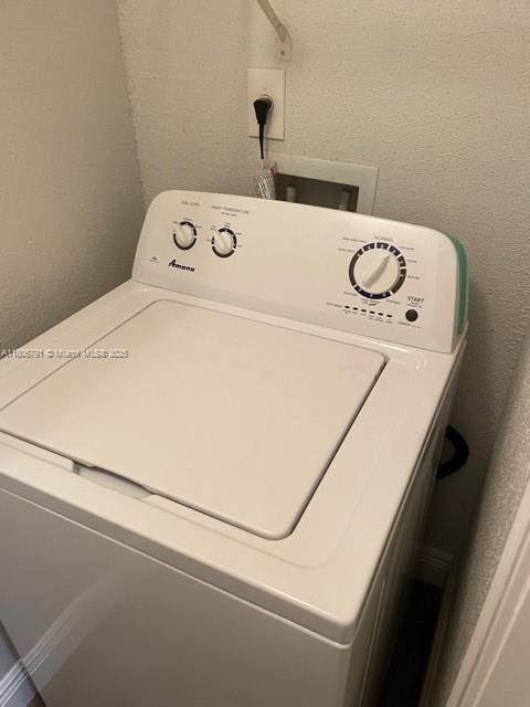 927 Riverside Dr Unit 326, Coral Springs, FL 33071 - laundry area with washer / dryer and a textured wall