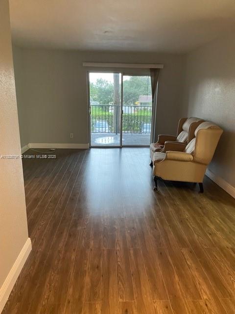 927 Riverside Dr Unit 326, Coral Springs, FL 33071 - sitting room featuring dark wood-style flooring and baseboards