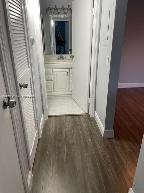 927 Riverside Dr Unit 326, Coral Springs, FL 33071 - hallway with wood finished floors, baseboards, and a sink