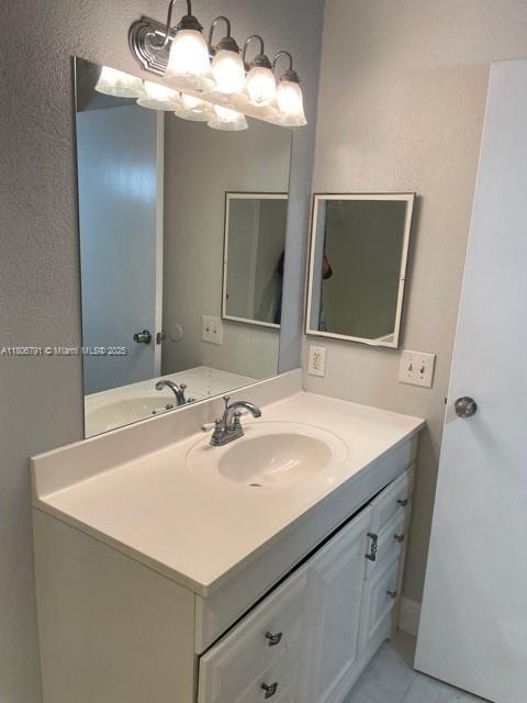 927 Riverside Dr Unit 326, Coral Springs, FL 33071 - bathroom featuring vanity and tile patterned floors
