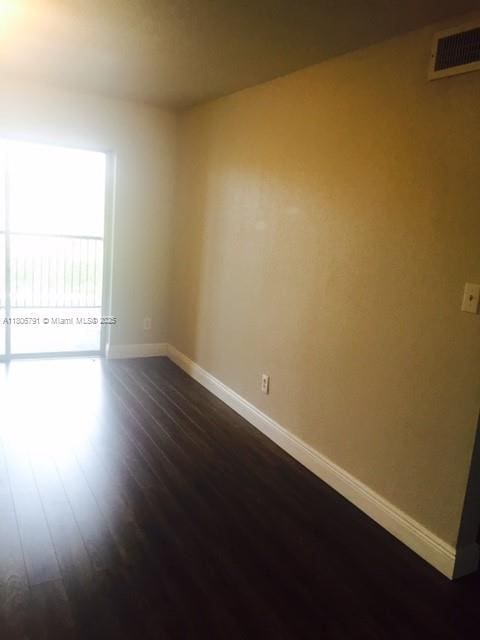 927 Riverside Dr Unit 326, Coral Springs, FL 33071 - spare room with baseboards and dark wood-style floors