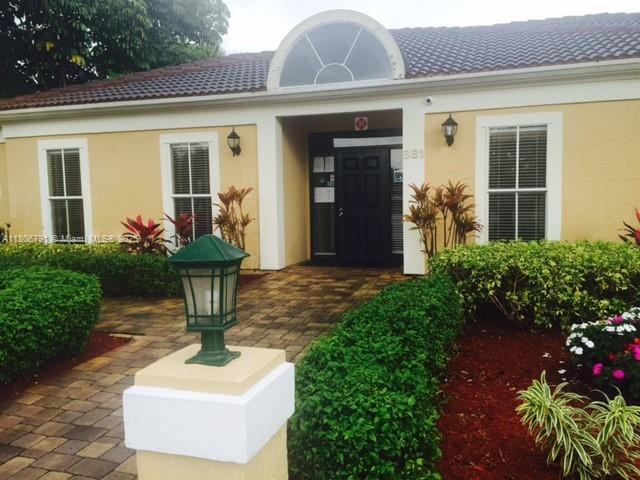 927 Riverside Dr Unit 326, Coral Springs, FL 33071 - doorway to property featuring stucco siding