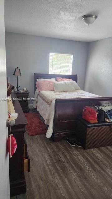 927 Riverside Dr Unit 326, Coral Springs, FL 33071 - bedroom featuring wood finished floors and a textured ceiling