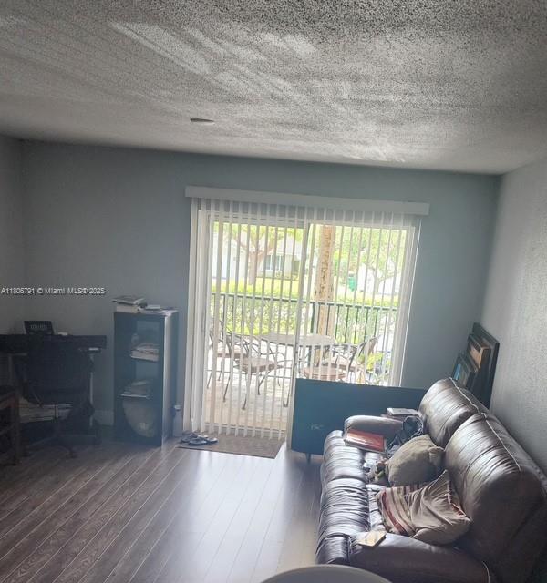 927 Riverside Dr Unit 326, Coral Springs, FL 33071 - living room with healthy amount of natural light, wood-type flooring, and a textured ceiling