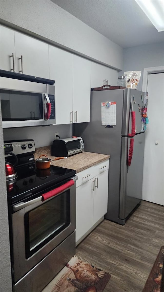 927 Riverside Dr Unit 326, Coral Springs, FL 33071 - kitchen featuring stainless steel appliances, dark wood finished floors, white cabinetry, and light countertops