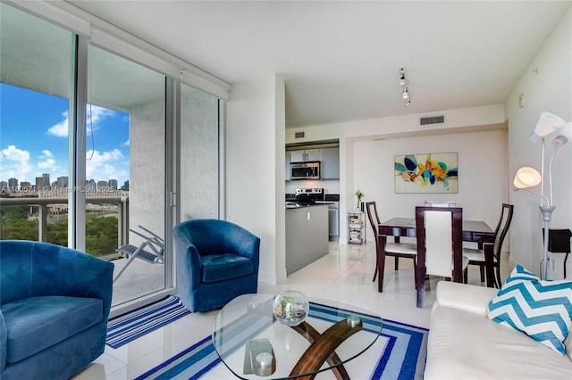 1871 NW S River Dr Unit 1407, Miami, FL 33125 - living area featuring light tile patterned flooring, a skyline view, and a wall of windows
