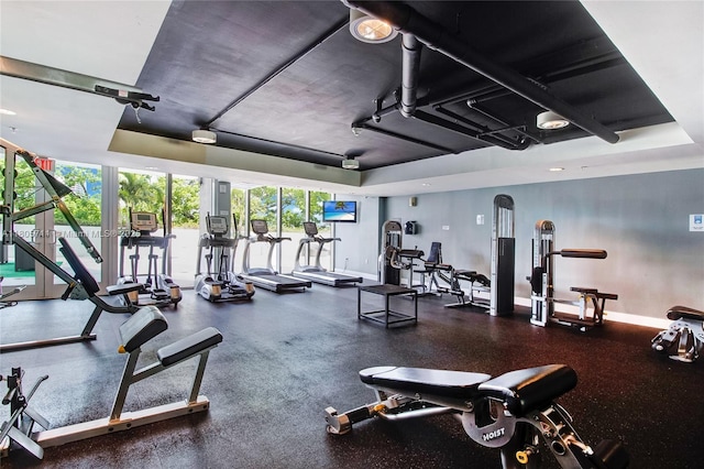 1871 NW S River Dr Unit 1407, Miami, FL 33125 - gym featuring baseboards and a wall of windows