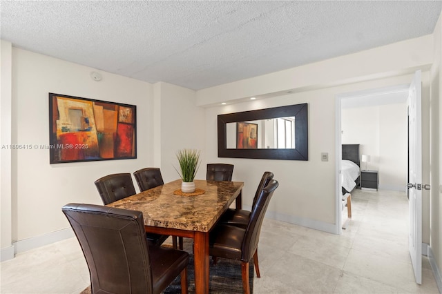 18181 NE 31st Ct Unit Ph07, Aventura, FL 33160 - dining room featuring a textured ceiling and baseboards
