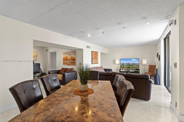 18181 NE 31st Ct Unit Ph07, Aventura, FL 33160 - dining space with a textured ceiling