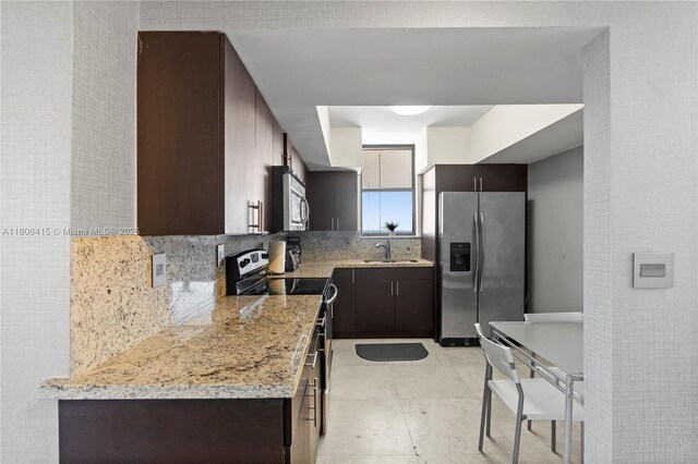 18181 NE 31st Ct Unit Ph07, Aventura, FL 33160 - kitchen with stainless steel appliances, a sink, backsplash, and dark brown cabinets